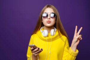 Young girl with a cell phone and headphones