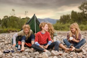 Children in front of a tent at an overnight camp/